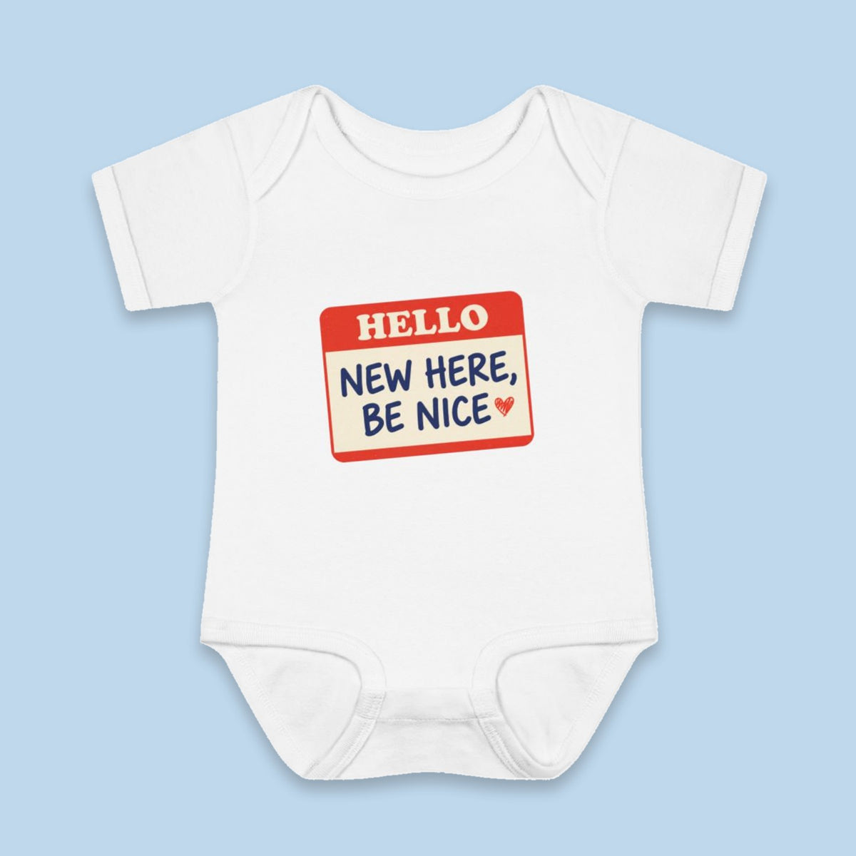 New Here, Be Nice onesie – Flat on blue background