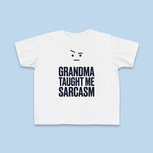 Grandma Taught Me Sarcasm toddler tee – Flat on blue background